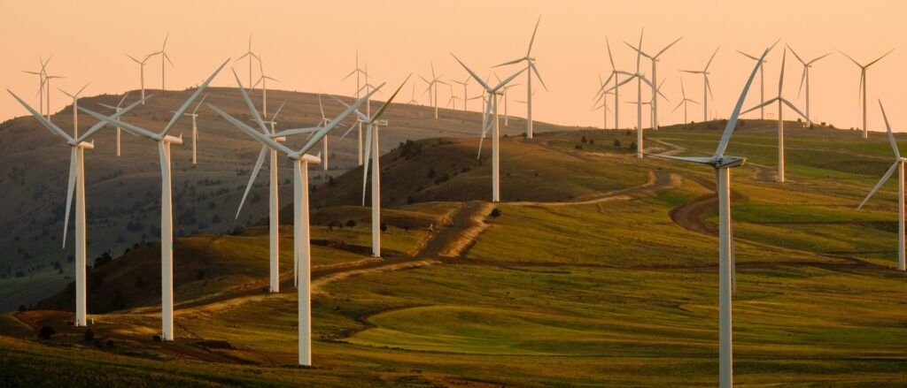 Wind turbines on grassy hills at sunset.

https://drawdown.org/solutions/onshore-wind-turbines