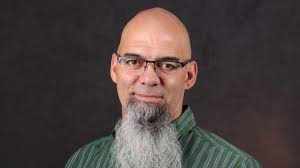 A bald man with a beard smiling